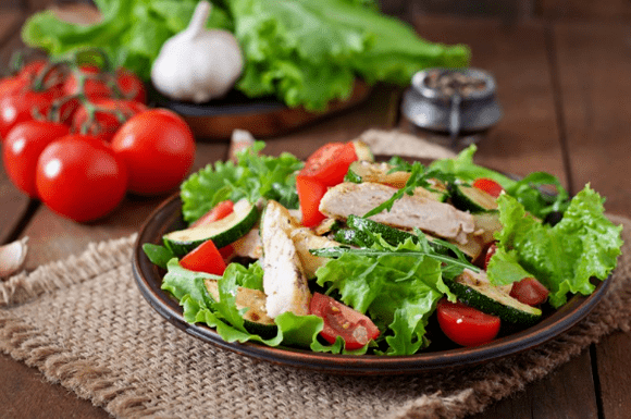 Chicken and vegetable salad is a great option for a light post-workout dinner. 