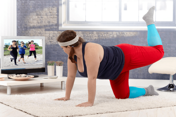 Overweight woman doing exercise to lose weight at home
